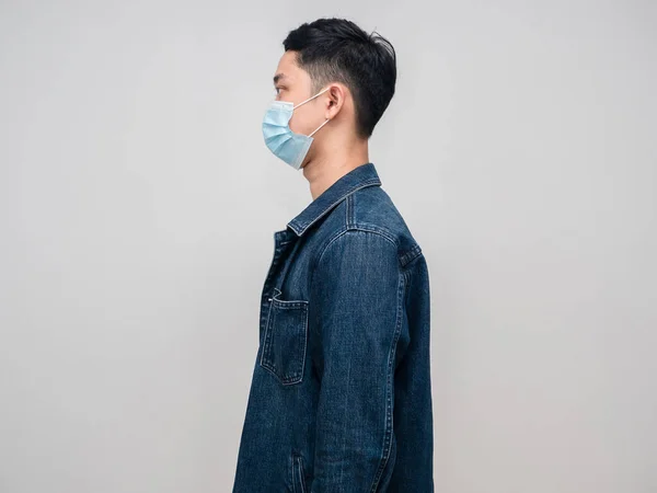Side view young man jeans shirt wear medical mask isolated