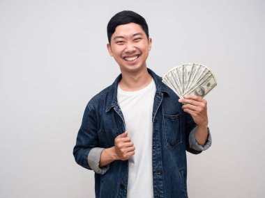 Cheerful asian man jeans shirt gentle smile earn money in hand isolated