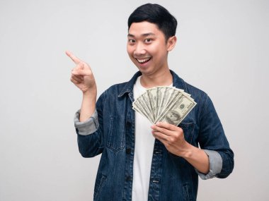 Young asian man jeans shirt show a lot of money with point finger