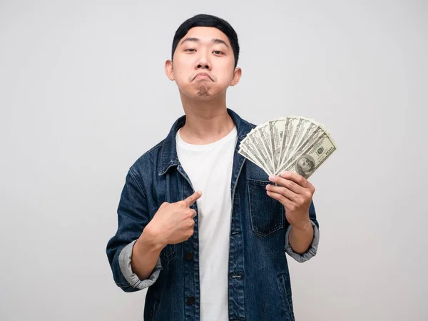 Young man jeabs shirt boast with money in hand point finger at himself isolated