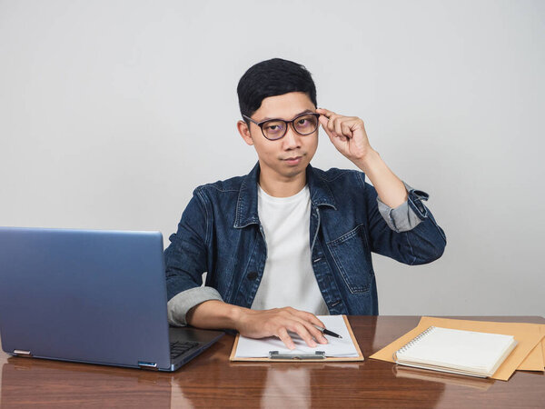 Handsome man wear glasses look confident sit at workplace