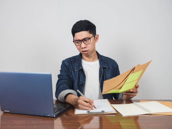 Businessman work hard and very busy at working table feels tried