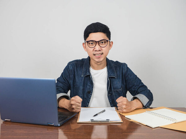 Young manager angry emotion hit the fist on working table