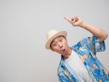 Positive man wear hat beach feels amazed point finger at copy space