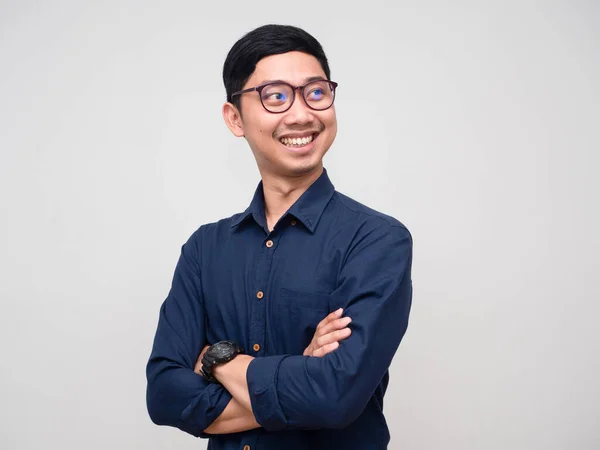 Portrait young businessman cross arms looking up