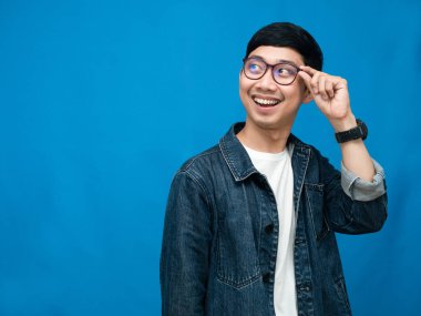 Cheerful man wear glasses happy smile turn around to looking blue background