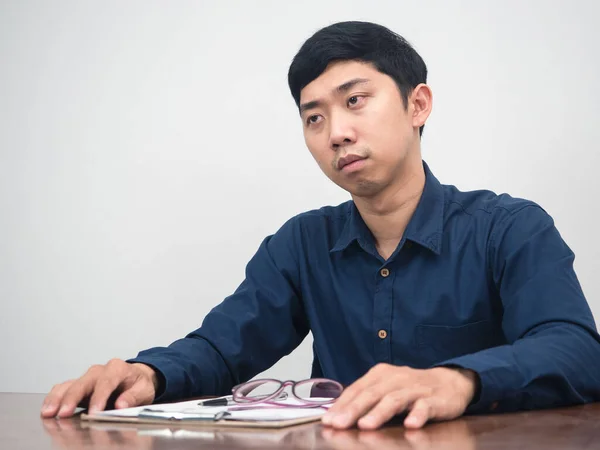 Asian man feels sadness about lay off employee sit at working table
