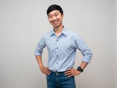 Positive man blue shirt stand at waist with happy smile