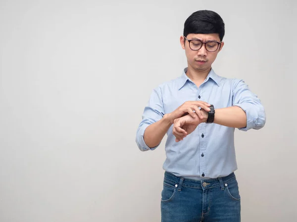 Young businessman busy looking at his watch copy space