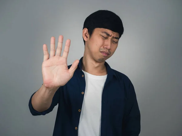 Asian man feels sad show hand up depressed hopeless
