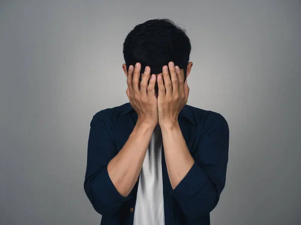 Depressed asian man crying about his life isolated