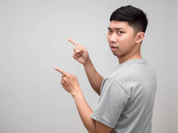 Asian man grey shirt confused turn around gesture point finger isolated