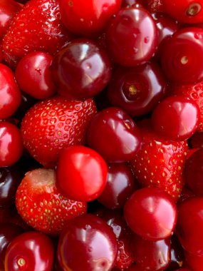 Büyük, sulu, yıkanmış kirazlar ve çilekler yakın plan.