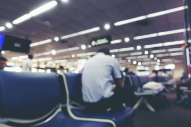 Havalimanı taşıma terminalinde yürüyen ya da acele eden birçok yolcunun soyut Görüntü Görüntü geçmişi ya da Bokeh ile birlikte havalimanı kontrol gişelerinde. Işık efektli klasik ton.