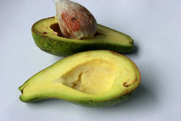 Ripe avacado on a white background. Bad cholesterol prevention food