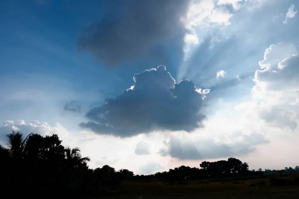 Sky blue and white light of the sun through the clouds in the sky.