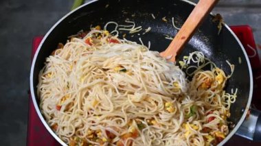 4K resolution super slow motion close up chef cooking fried noodle in pan, street food at bangladesh.
