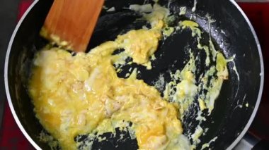 Putting frying pan with freshly fried eggs on table with served nourishing balanced breakfast - morning meal preparation 4k footage.