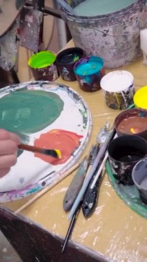 Almaty, Almaty region, Kazakhstan, 14/06/2022. Vertical video, artist paints in an art workshop