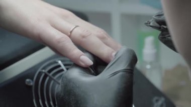 The process of manicure in a beauty salon close-up. Cuticle removal