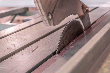 Sawing machine for wood in the workshop for the production of furniture. Woodworking circular saw for cutting.
