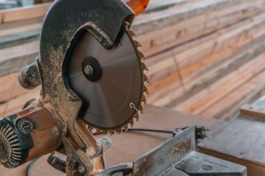 Sawing machine for wood in the workshop for the production of furniture. Woodworking circular saw and wooden bar for cutting.