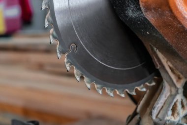 Sawing machine for wood in the workshop for the production of furniture. Woodworking circular saw and wooden bar for cutting.