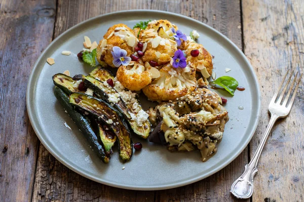 Vegan mix of miso aubergine, roasted cauliflower and baby courgettes