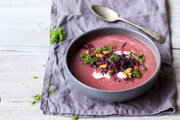 Red cabbage soup with crispy cabbage and walnuts topping