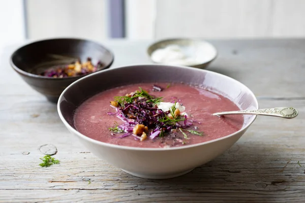 Red cabbage soup with crispy cabbage and walnuts topping