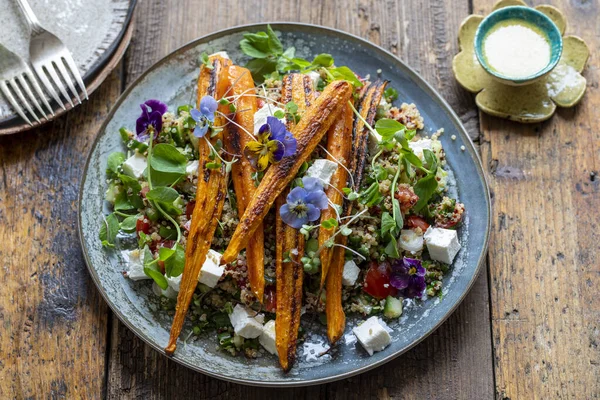 Quinoa salad with roast carrots and vegan cheese