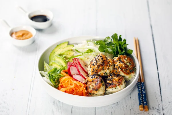 Turkey mince meat balls with pickled carrots, radishes, avocado and rice
