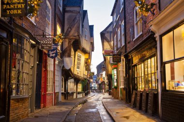 YORK, UNITED KINGDOM - 16th DECEMBER, 2018: The Shambles is one of the best-preserved medieval shopping streets in Europe.City of York gets decorated with Christmas lights. clipart