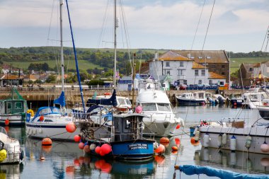 WEST BAY, UK - MAY 26th, 2019: West Bay, also known as Bridport Harbour, is a small harbour settlement and resort on the English Channel coast in Dorset.