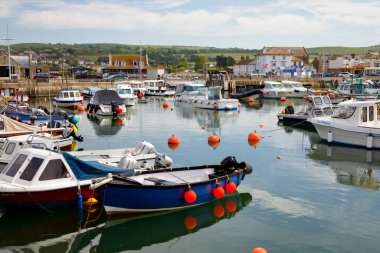 WEST BAY, UK - MAY 26th, 2019: West Bay, also known as Bridport Harbour, is a small harbour settlement and resort on the English Channel coast in Dorset.