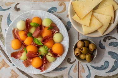 Spanish tapas, melon and ham, olives and cheese