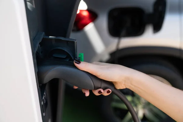 Woman holding plug of electric car — Stock Photo, Image