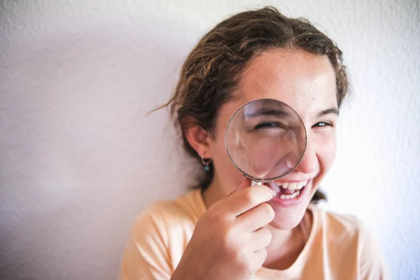 portrait of a girl with magnifier on her face