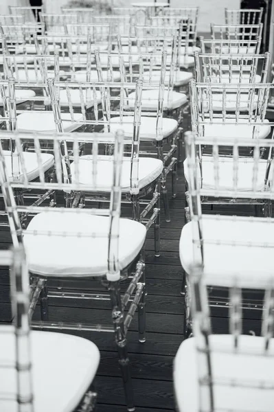 Γυάλινες καρέκλες στέκονται στη σειρά σε μια όμορφη τελετή εξόρμησης γάμου — Φωτογραφία Αρχείου