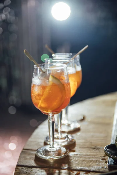 Glasses with different cocktails. Long and short cocktails at a party with disco lighting.