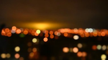Blurred view of the night city. Evening lights light up the sky. Abstract bright blurred colored bokeh. Bokeh lights in the city night background
