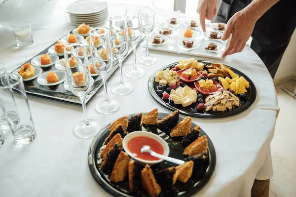 A wide variety of snacks on the table for guests. Shrimp, boiled pork, various types of meat and other products.