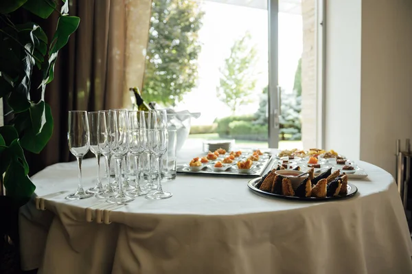 A wide variety of snacks on the table for guests. Shrimp, boiled pork, various types of meat and other products.