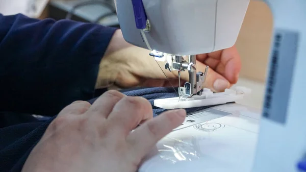 sewing fabric on the machine