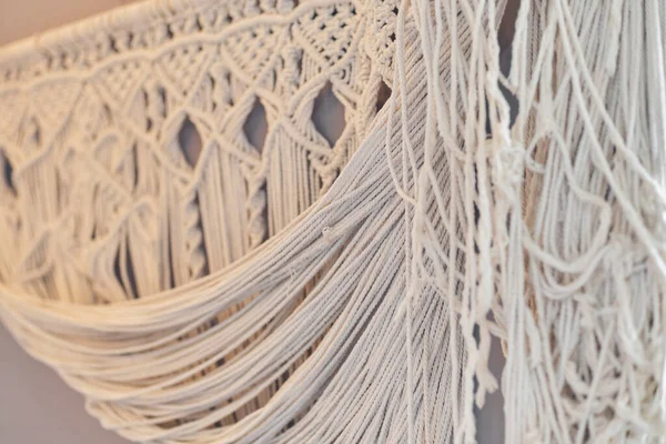 Beautiful boho macrame on wall panel. tapestry in the style of Boho made of cotton threads in natural color using the macrame technique for home decor and wedding decoration. light pastel colors — Stock Photo, Image