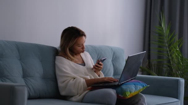 Mulher de negócios cansada esfrega os olhos trabalhando em um laptop na cama. Empresária trabalha tarde preparando documentos. — Vídeo de Stock