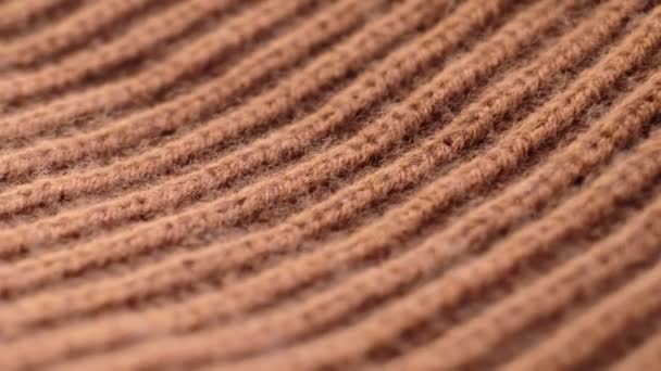 Closeup the motion footage vide. Textile abstract background. Clothing industry concept. Wavy clean material. Fibers of knitted clothes brown white threads. Knitted fabric threads macro. — Video Stock