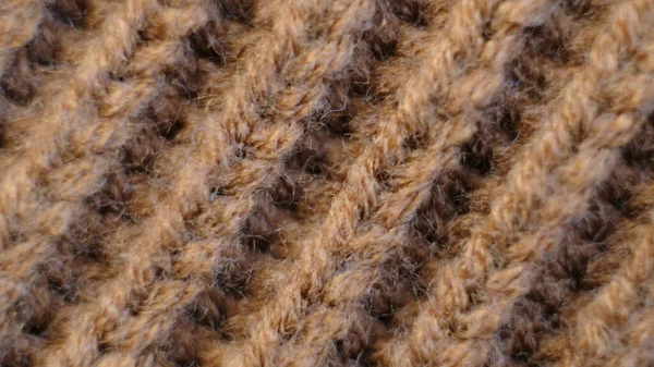 Textile abstract background. Clothing industry concept. Wavy clean material. Fibers of knitted clothes brown white threads. Knitted fabric threads macro — Fotografia de Stock