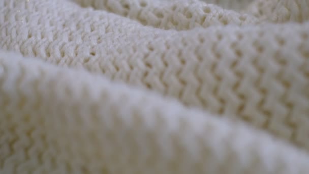 Closeup the motion footage vide. Textile abstract background. Clothing industry concept. Wavy clean material. Fibers of knitted clothes with white threads. Knitted fabric threads macro. — Video Stock