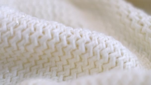 Closeup the motion footage vide. Textile abstract background. Clothing industry concept. Wavy clean material. Fibers of knitted clothes with white threads. Knitted fabric threads macro. — Vídeo de Stock